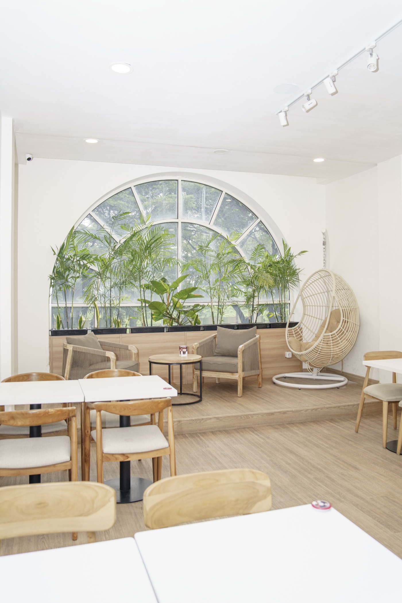 The arched window and hanging egg chair on the second floor