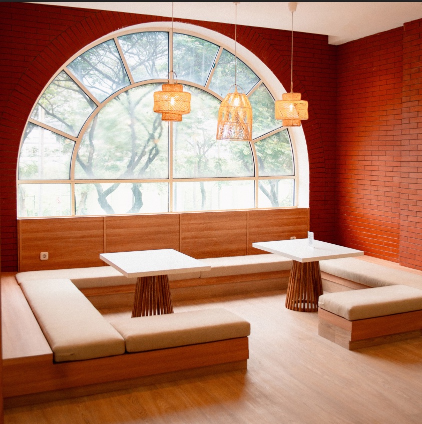 Twig's dining room — banquette seating beneath a tall arched window